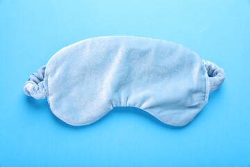 Soft sleep mask on light blue background, top view