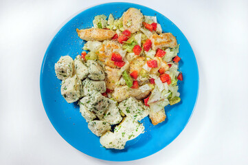 Breaded chicken breast with potato salad.Studio shot.