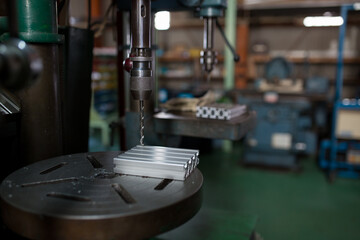 Drilling work on an aluminum frame with a drill press
