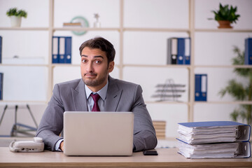 Young male employee working in the office