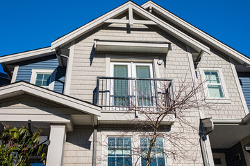 Top of a house with nice windows. Dormer and a blue sky. Real Estate Exterior Front House in a residential neighborhood