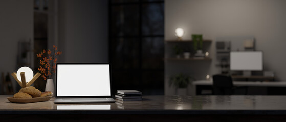 Fototapeta na wymiar Workspace close-up with laptop mockup on tabletop in modern dark home office.