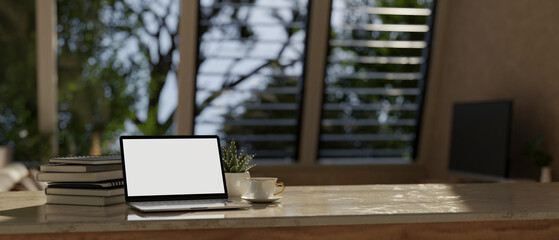 close-up image, Workspace with laptop mockup on tabletop over blurred room in the background.