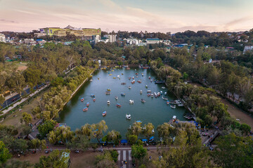 Baguio City, Philippines - Aerial of the man made lake of Burnham Park, with SM Baguio in the...