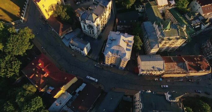 Top down view of the old city in the center of Kyiv, Ukraine. The drone flies over the roofs of ancient buildings and streets of Andreevsky Descent in the capital of Ukraine.
