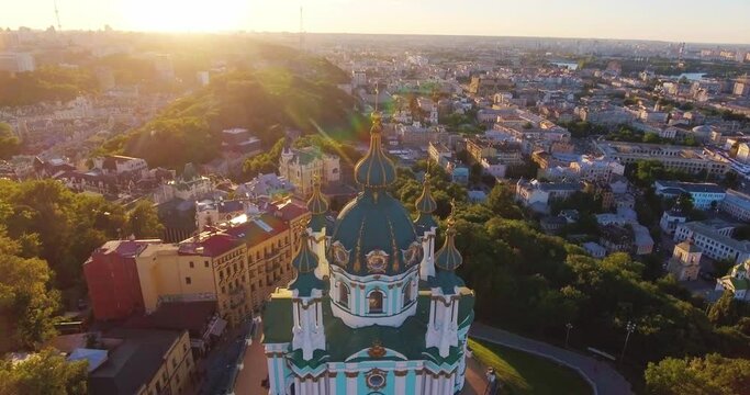 City Kyiv Ukraine. Aerial view. Cityscape with ancient churches and ancient buildings in the city center in a beautiful sunset. drone flies over the old church on Andreevsky descent.