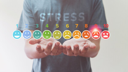 Man Holding of stress meter colorful icon virtual screen interface, emotions from happy blue to red...