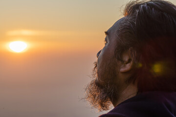 man with a beard with face raised up to sky and eyes looking on sunny summer day. 50-59 years old,