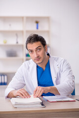 Young male doctor working in the clinic