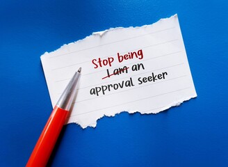 Torn paper on blue background with text written STOP BEING AN APPROVAL SEEKER, to overcome addiction to approval and validation from others and have self-validating instead