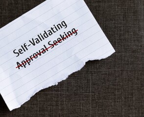 Torn paper on black background with text written APPROVAL SEEKING crossed off to SELF-VALIDATING,...
