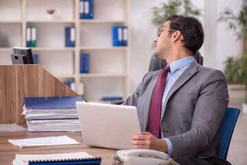 Young male employee working in the office