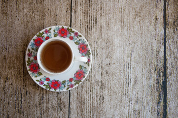 Cup of tea on wooden table.