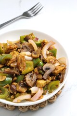 Fresh stir fried or sauteed vegetables. broccoli, zucchini, green and red peppers, mushrooms, onions, baby corn. colorful veggies in a white plate. Weightloss journey. Fitness concept. Healthy life.