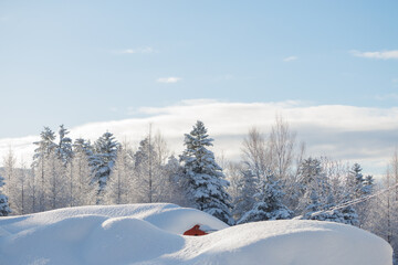 Red shed buried under mound of fresh snow