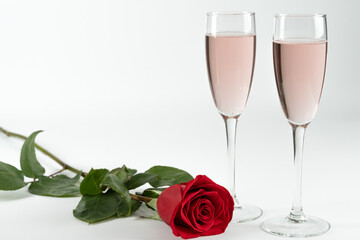 two glasses of champagne and a rose