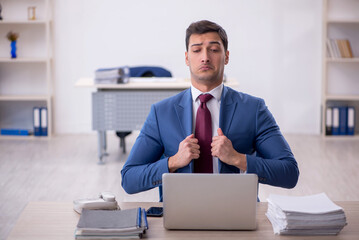 Young male employee working in the office