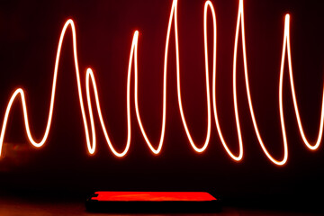 Abstract red lines drew by using long exposure of camera and flash light shape of graphic. Investing in the online puppet market. Network internet mobile wireless business concept 