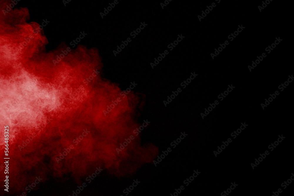 Wall mural red powder explosion cloud on black background. freeze motion of red color dust particles splashing.