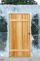 The wooden door on the ice wall around the Christmas tree is closed with a padlock