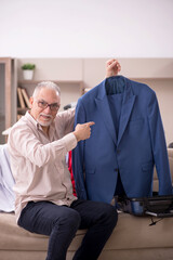 Fototapeta premium Old man preparing for trip at home