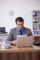 Young male employee working in the office