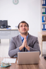 Young male employee working in the office