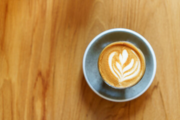 hot cappuccino coffee on wood table with copy space