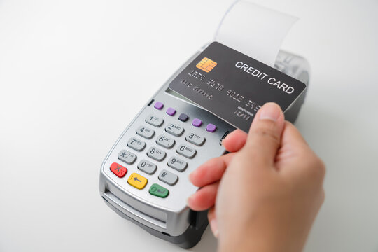 Customer using credit card for payment by NFC technology on card reader machine.