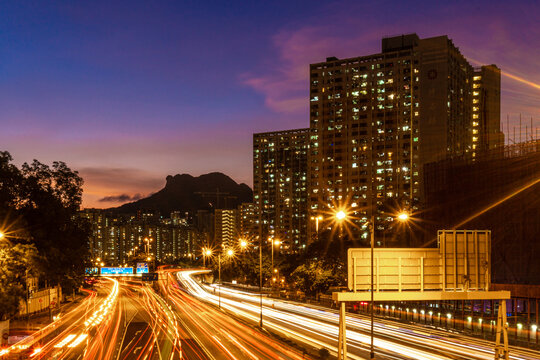 Night skyline and cityscape of residential building, public rental housing, Lion Rock Mountain at Hong Kong, Ping Shek Estate with light trails
