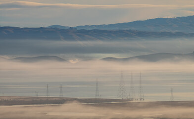 mist over bay and hills