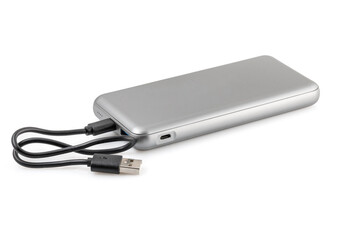 Additional autonomous power bank for charging mobile devices. External battery isolated on white background. Silver charger for a smartphone with a power supply (battery). Full depth of field.