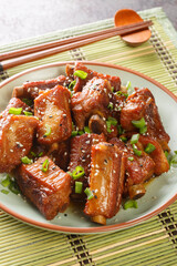 Sweet and Sour Rib Tang Cu Pai Gu is a quite popular dish in China close-up in a plate on the table. Vertical