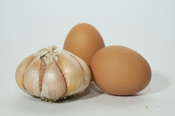 close up of egg and garlic isolated on white background
