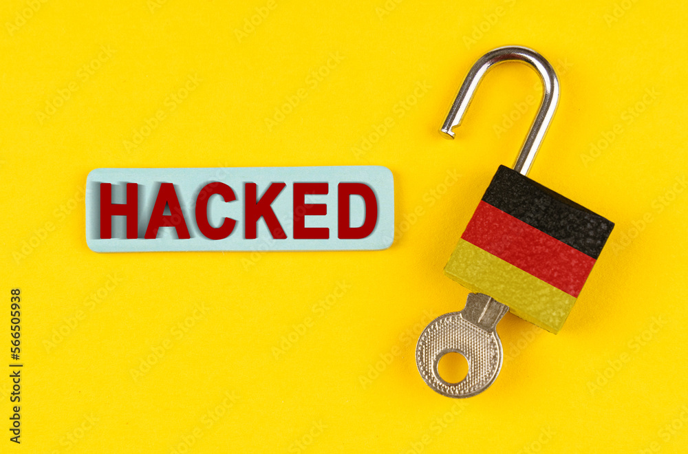Poster On the yellow surface is an open lock with a key and a sticker with the inscription - hacked