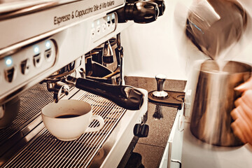 Barista preparing coffee at coffee machine. Coffee shop counter