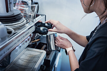 Barista preparing coffee at coffee machine. Coffee shop counter