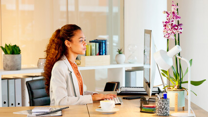 Young lawyer typing on a computer keyboard, planning defence and closing arguments for a paralegal court case. A confident and ambitious female attorney researching evidence on trial for client