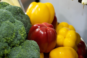 Close up of various colorful raw vegetables like red yellow capsicum or bell paper  and broccoli 