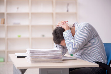 Obraz premium Young male employee working in the office