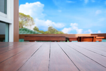 Perspective brown wooden table on top over blur sky background, can be used mock up for montage products display or design layout.