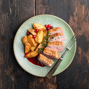 Duck Breast With Potatoes And Berry Sauce In A Ceramic Plate, View From Above