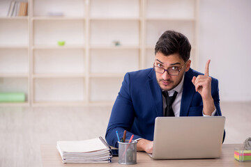 Young male employee working in the office