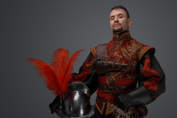 Shot of handsome musketeer man with beard dressed in stylish costume.