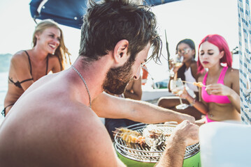 Friends making fish barbecue on the yacht