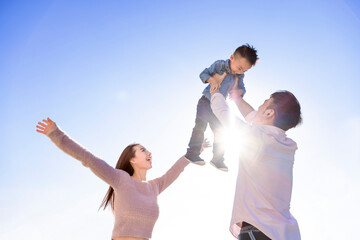 Happy Asian family  standing and playing with son