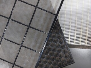 Close-up on dirty Air Purifier Filter component : Pre Filter, Carbon Filter, and HEPA filter to trap dust, virus, bacteria and pollutants in the air