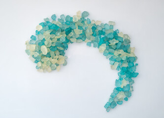 Top view of heap of natural sea salt on white background.