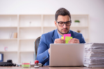 Young male employee unhappy with excessive work in the office