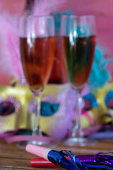 carnival mask, noisemaker, champagne and streamers, carnival or new year party concept